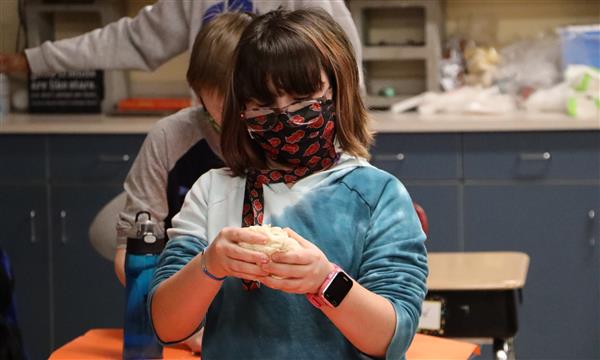 Girl shapes salt dough